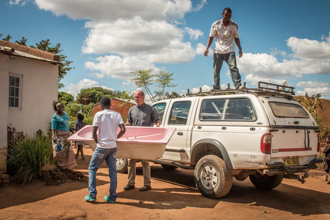 Missionary unloading a mobile baptismal in Africa