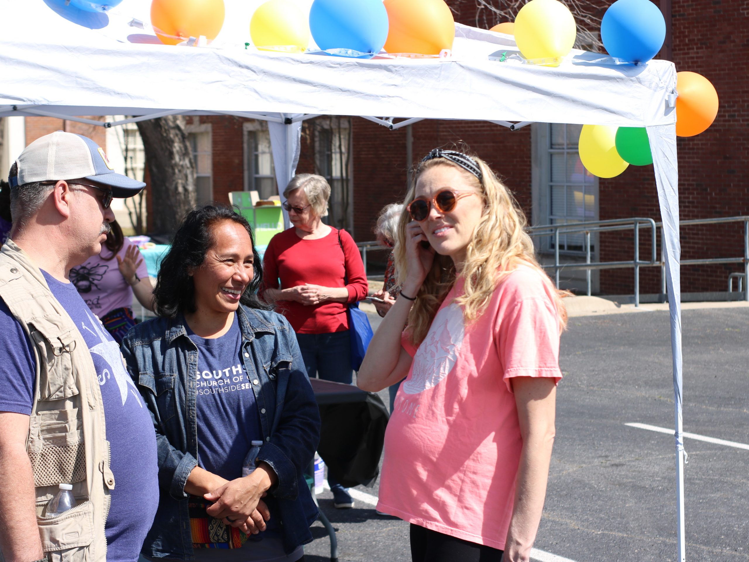 Three Southside Partners in the Gospel beneath the welcome tent at Day of H.O.P.E. 2022