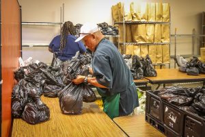 Our Food Pantry ministry leader preparing sacks